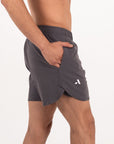 Person wearing gray athletic shorts on a white background