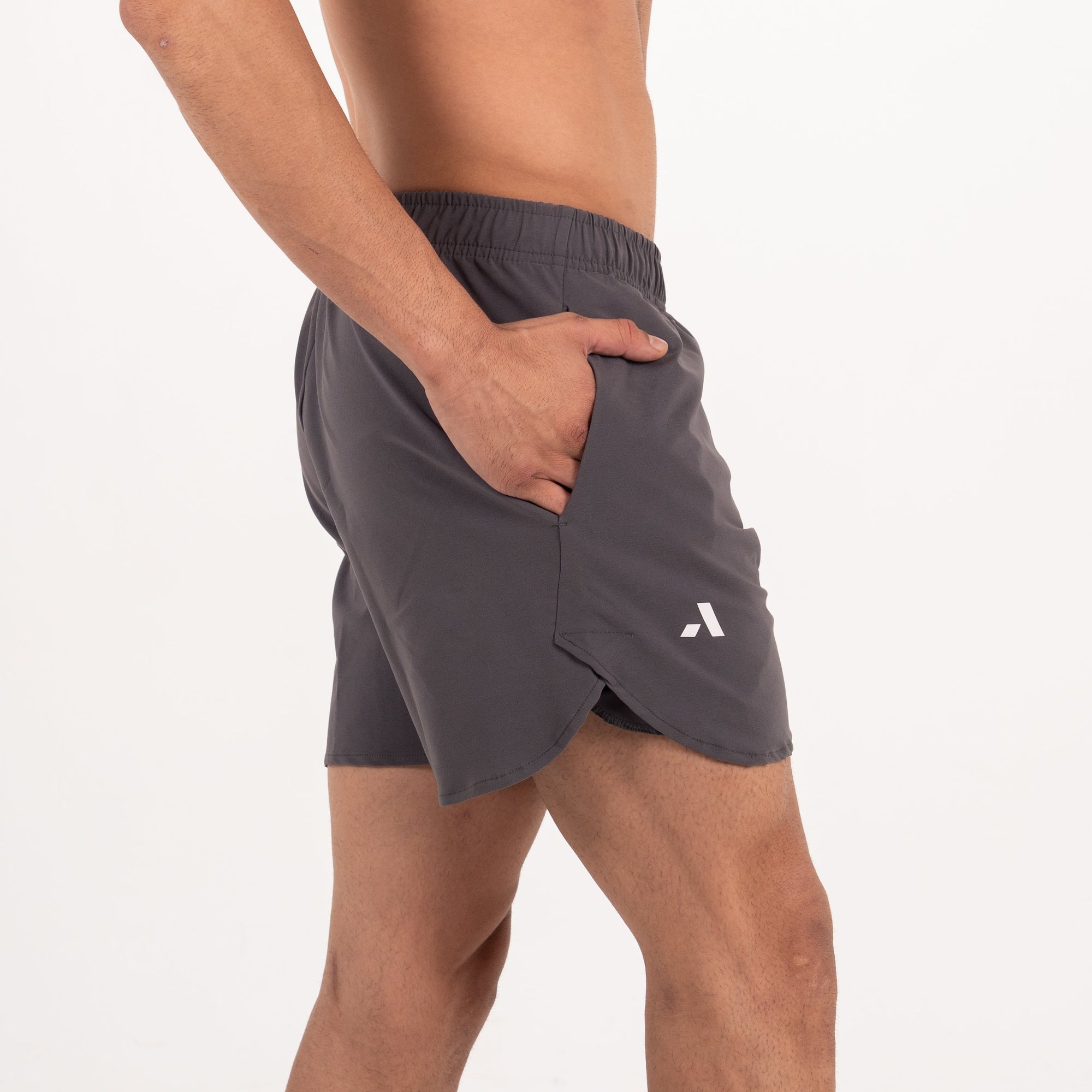Person wearing gray athletic shorts on a white background